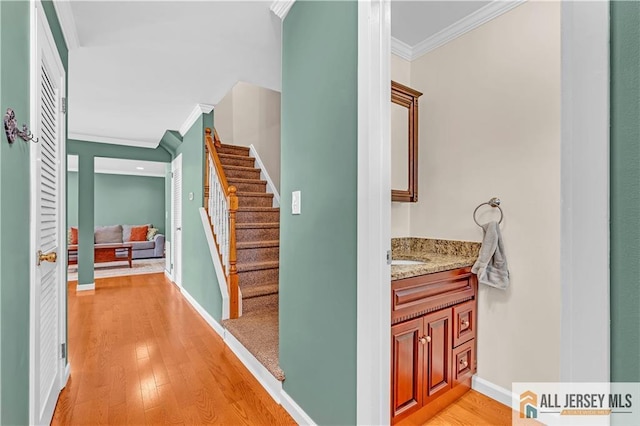 2507 Balmoral Ct, Hillsborough, NJ 08844 - hallway with crown molding, stairway, and light wood-style floors