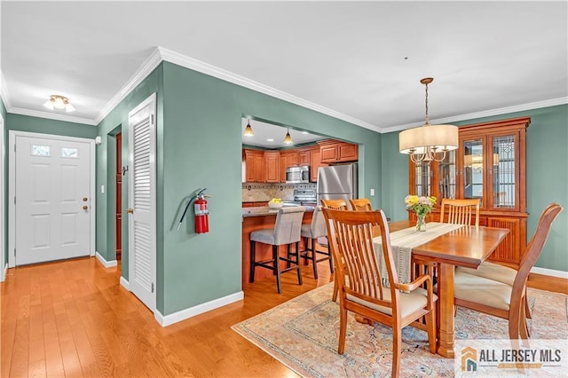 2507 Balmoral Ct, Hillsborough, NJ 08844 - dining room with a chandelier, light wood-type flooring, and ornamental molding