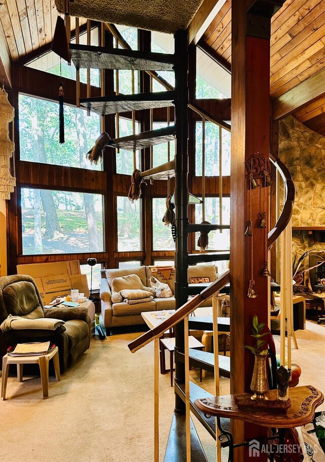 living room featuring plenty of natural light, carpet, beamed ceiling, and high vaulted ceiling