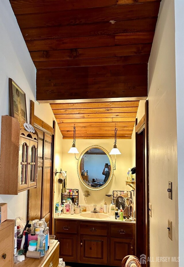 bathroom with vanity, wood ceiling, and lofted ceiling