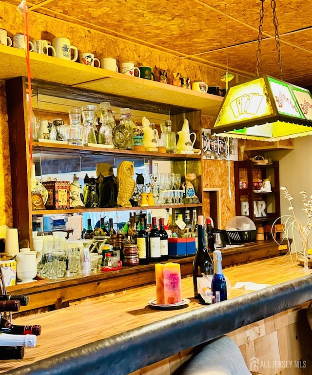 bar with hardwood / wood-style floors and decorative light fixtures