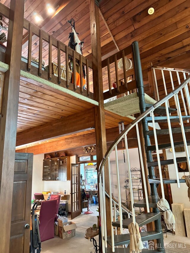 stairs with wooden ceiling and french doors