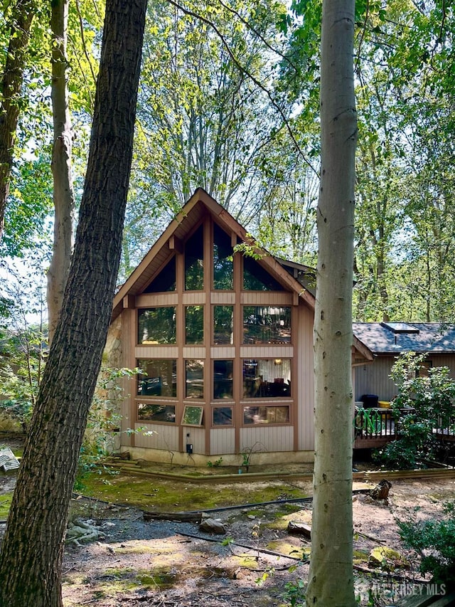 rear view of house featuring a deck