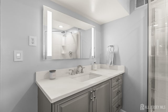 full bathroom with a stall shower and vanity