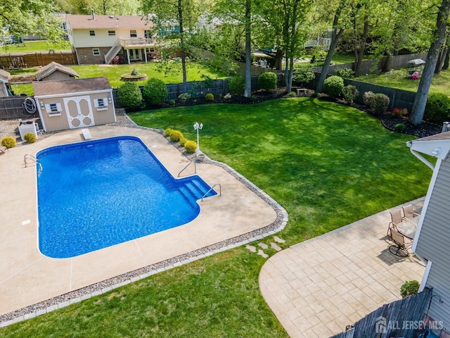 view of swimming pool with a storage shed, an outbuilding, a patio area, and stairs