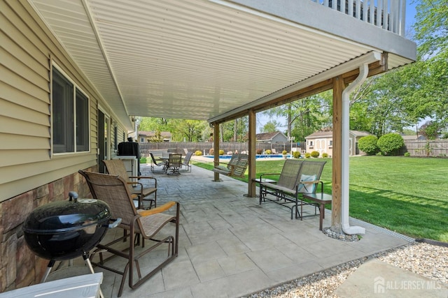 view of patio / terrace featuring outdoor dining space and an outbuilding