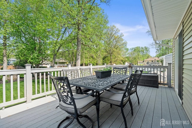 wooden terrace with outdoor dining space