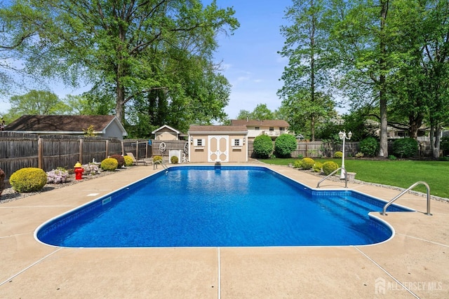view of pool featuring a storage shed, a patio, and an outbuilding