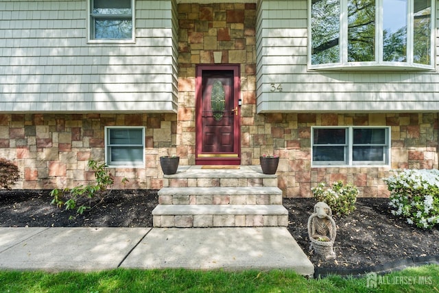 property entrance with stone siding