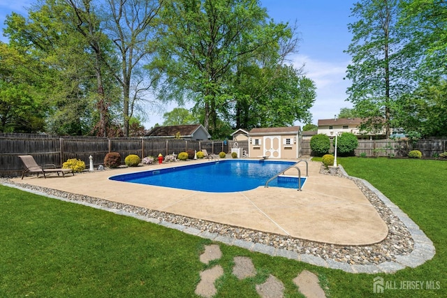 view of swimming pool with a patio, an outbuilding, and a shed
