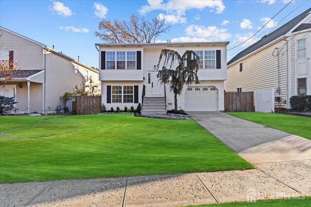 split foyer home featuring a garage and a front lawn