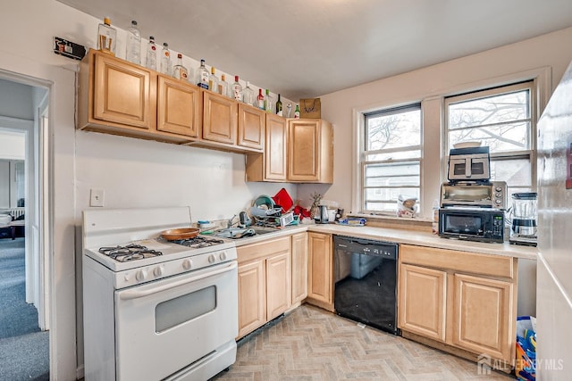 kitchen featuring light parquet flooring, sink, light brown cabinets, and black appliances