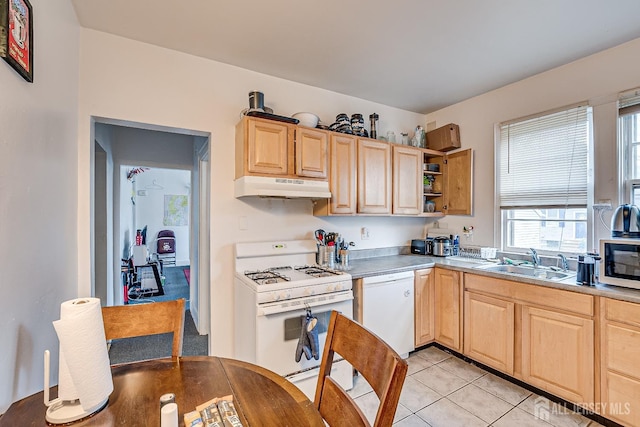 kitchen with white appliances, light tile patterned floors, sink, and light brown cabinets