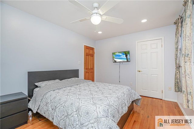 bedroom featuring hardwood / wood-style flooring and ceiling fan