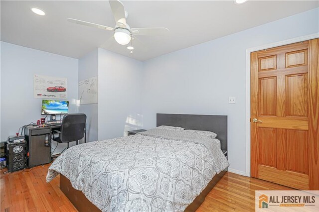 bedroom with ceiling fan and light hardwood / wood-style floors