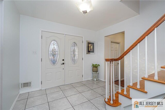 entryway featuring light tile patterned flooring