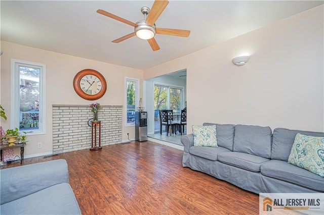 living room with hardwood / wood-style flooring and ceiling fan