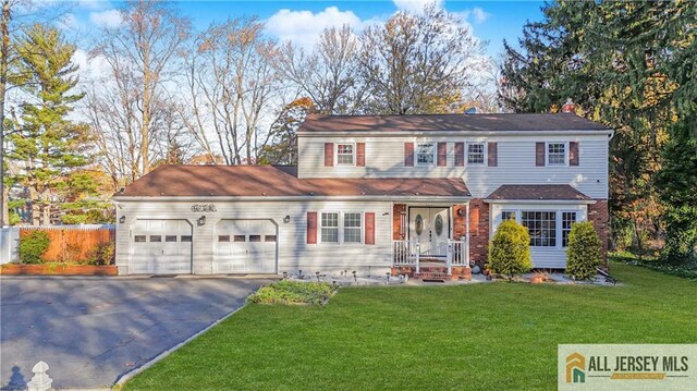 view of front of house featuring a garage and a front lawn