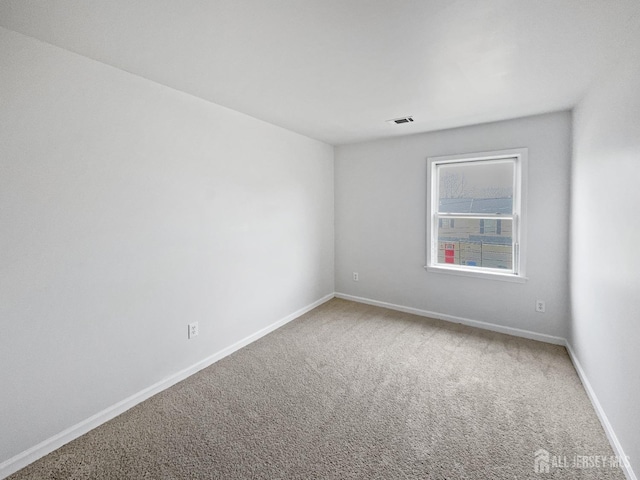 empty room with carpet floors and baseboards