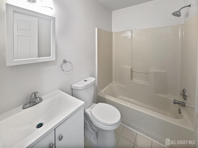 bathroom with toilet, tile patterned flooring, vanity, and shower / washtub combination