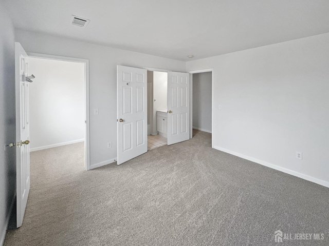 unfurnished bedroom featuring carpet and baseboards