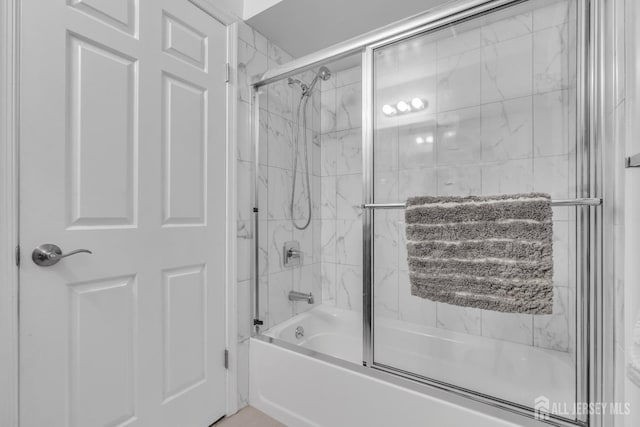 full bath featuring combined bath / shower with glass door