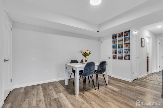 dining area with wood finished floors and baseboards