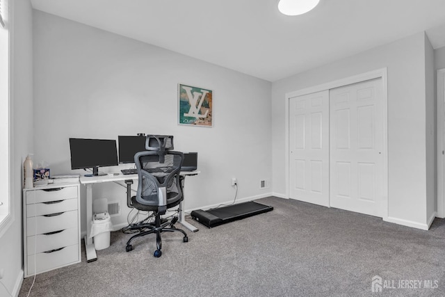 carpeted office space featuring baseboards