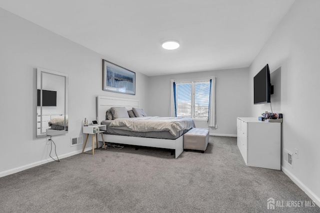 carpeted bedroom with visible vents and baseboards