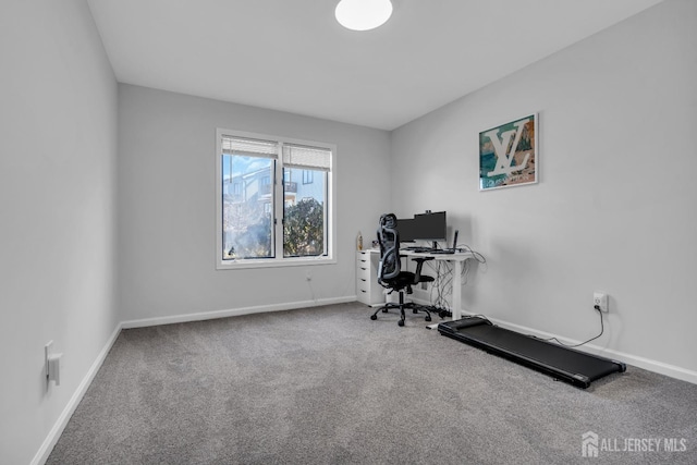 workout room featuring baseboards and carpet