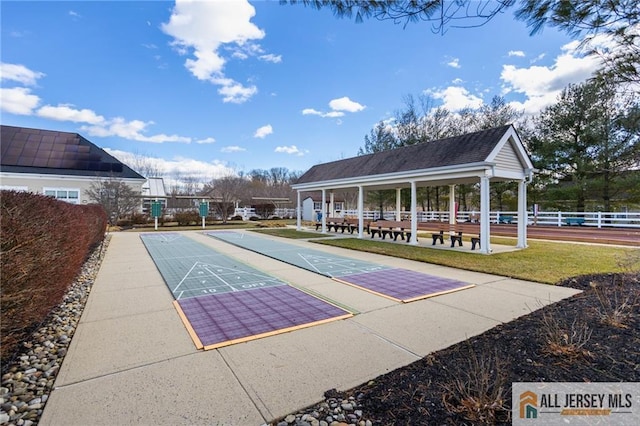 view of home's community featuring shuffleboard, a gazebo, and fence