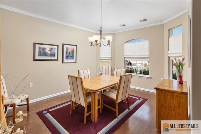 dining room with baseboards, visible vents, dark wood-style floors, ornamental molding, and a chandelier