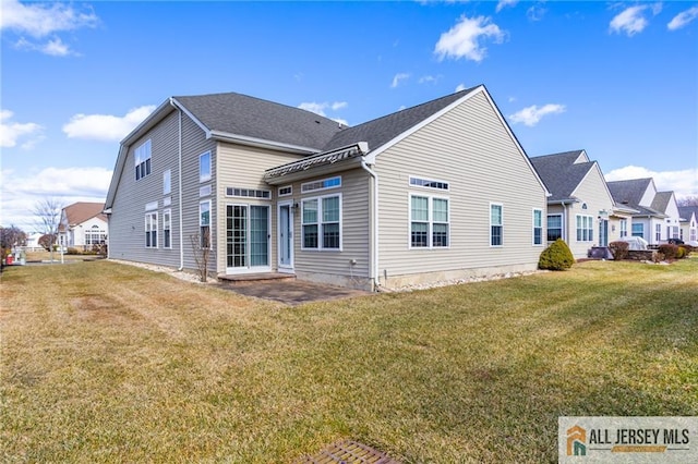 back of property with a yard and a residential view