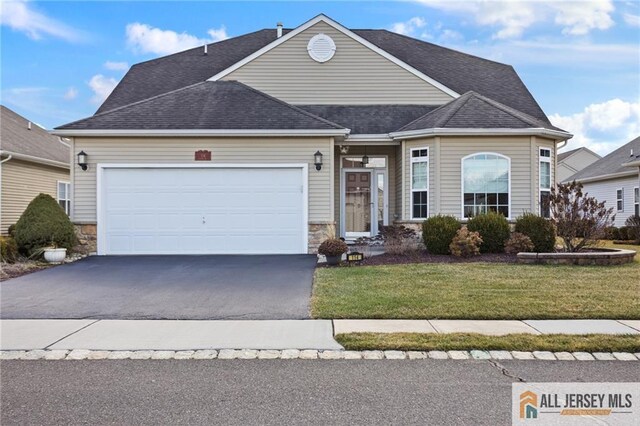 view of front of home with a garage and a front yard