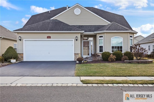 view of front of property featuring a garage, stone siding, aphalt driveway, and a front yard