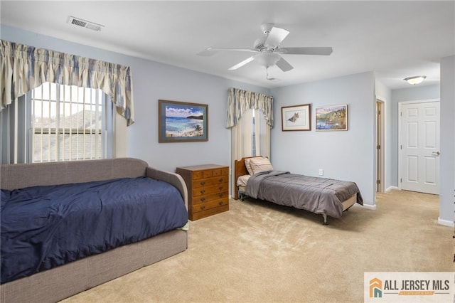 bedroom featuring carpet floors, baseboards, visible vents, and a ceiling fan