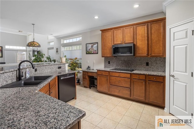 kitchen featuring tasteful backsplash, ornamental molding, brown cabinets, black appliances, and a sink