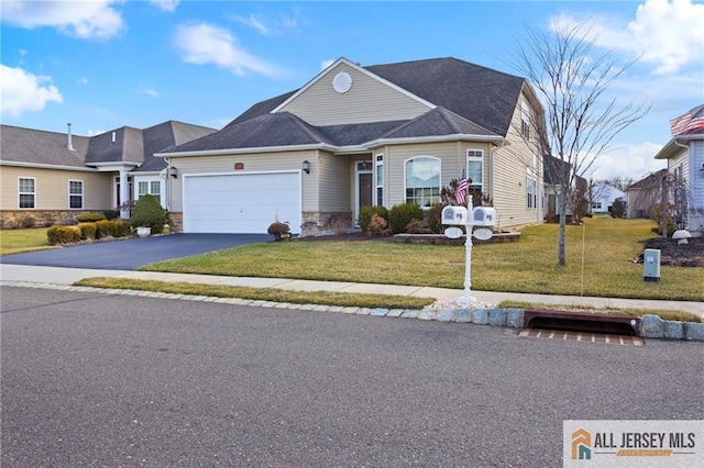 view of front of property with a garage, driveway, and a front yard