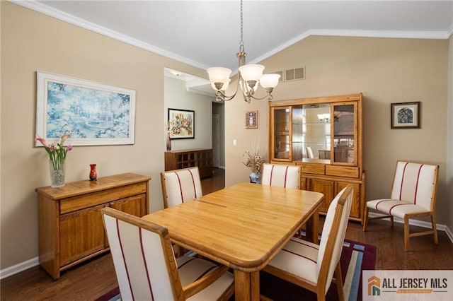 dining space with dark wood-style floors, lofted ceiling, visible vents, an inviting chandelier, and ornamental molding