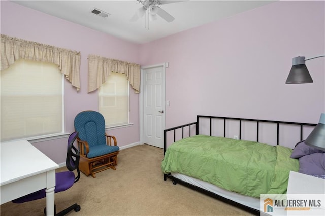 bedroom featuring a ceiling fan, carpet, visible vents, and baseboards