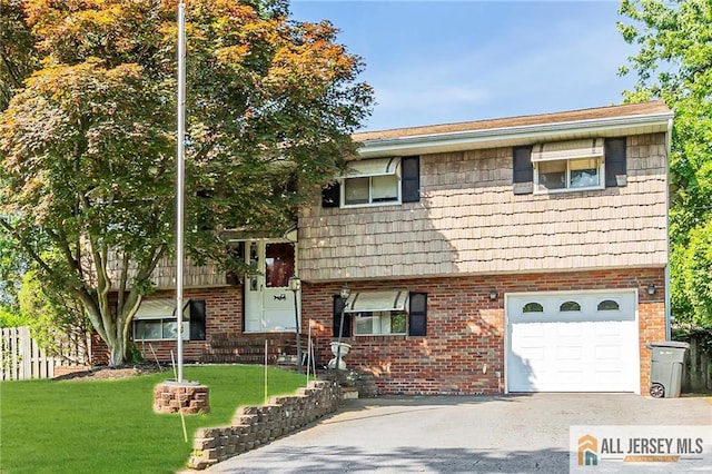260 Grant Ave, Piscataway, NJ 08854 - view of front of property with brick siding, an attached garage, a front lawn, and driveway