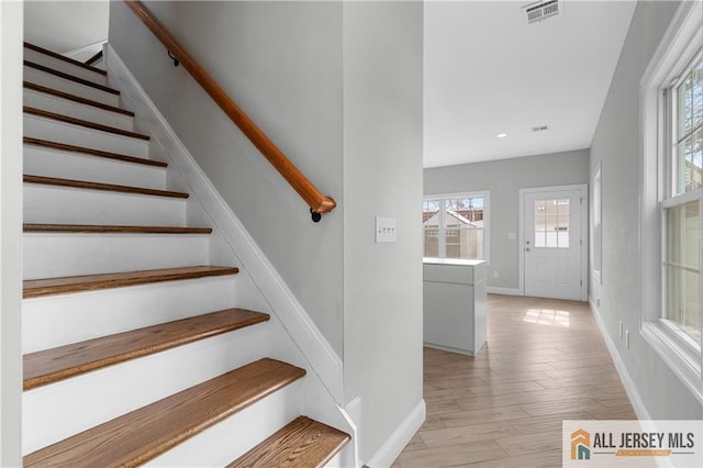 stairs featuring recessed lighting, wood finished floors, visible vents, and baseboards