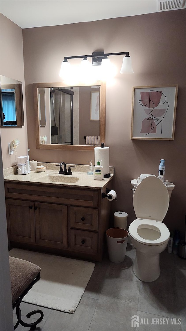90 Clay St, North Brunswick, NJ 08902 - bathroom featuring vanity, toilet, and tile patterned flooring