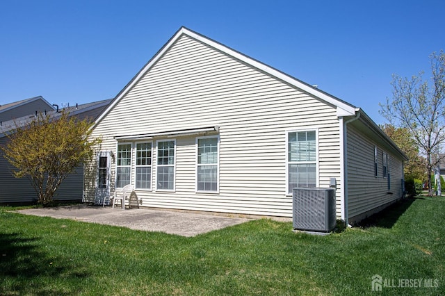 back of property featuring a lawn, a patio area, and central air condition unit