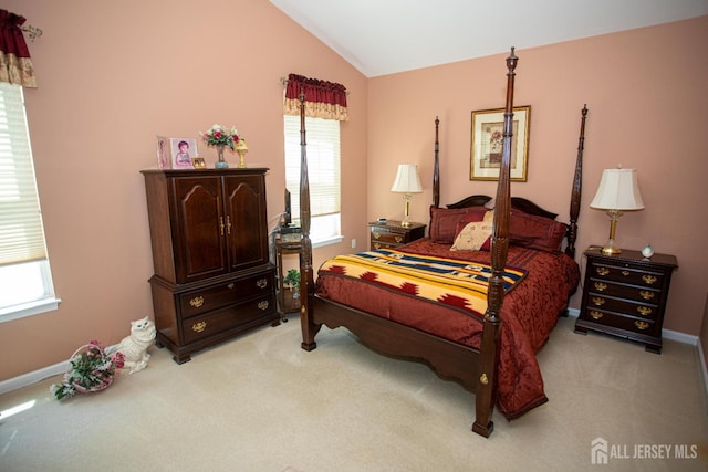bedroom with baseboards, light carpet, and vaulted ceiling