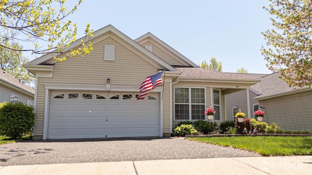 ranch-style home featuring an attached garage and driveway