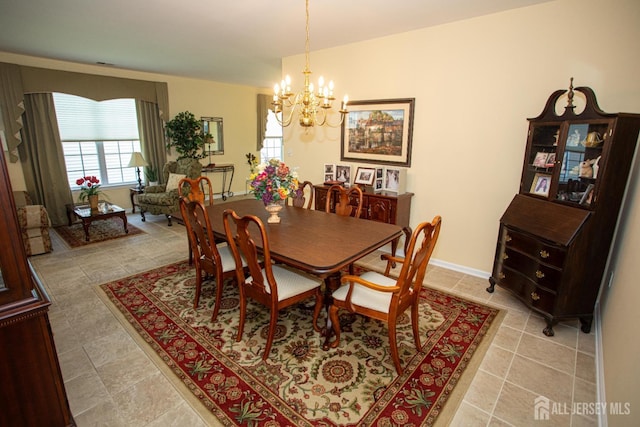 dining room featuring light tile patterned floors and a notable chandelier