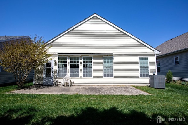 back of house with a lawn, a patio, and central AC unit