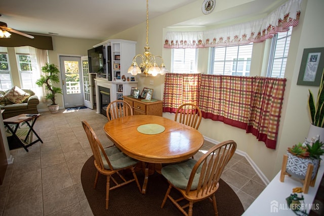 104 Prusakowski Blvd, Sayreville, NJ 08859 - tiled dining room with a ceiling fan and a glass covered fireplace