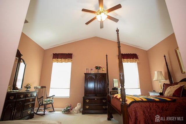 bedroom featuring a ceiling fan, light colored carpet, and lofted ceiling